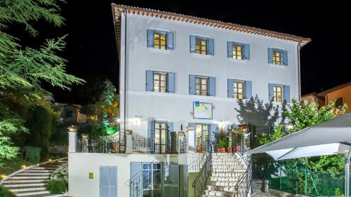 a large white building with stairs in front of it at VILLA CAPPELLETTI 16&2, Emma Villas in Cesi
