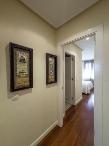 a room with two pictures on the wall and a bedroom at Apartamentos Verdemar (VUT) in Llanes