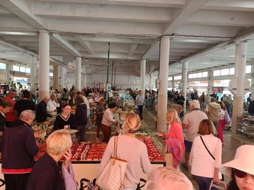 Un groupe de personnes se promenant autour d'un marché alimentaire dans l'établissement Joli Studio Cannes, à Cannes