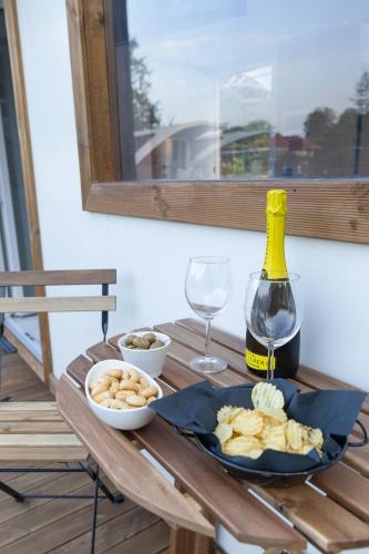a table with a plate of food and a bottle of wine at Floating Dream in Fiano
