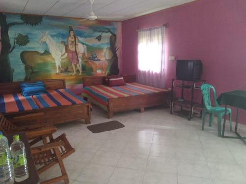 Postel nebo postele na pokoji v ubytování Sanhinda Royal Village