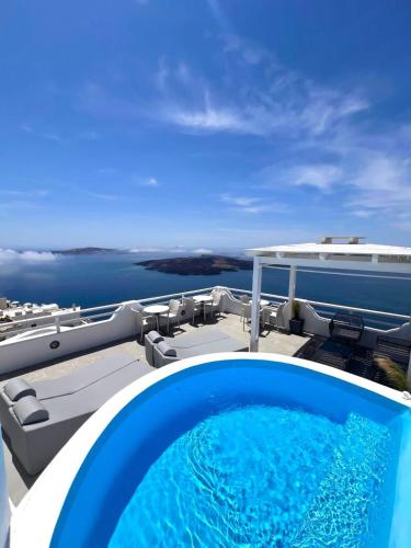 a swimming pool on the deck of a house at Kafieris View in Firostefani