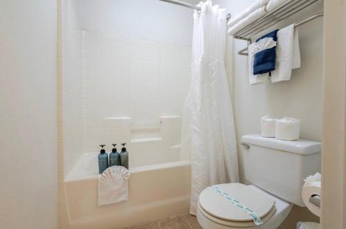 a white bathroom with a toilet and a shower at Pacific Plaza #504 - Heart of Oceano Condo - 1BdrmD-King in Oceano