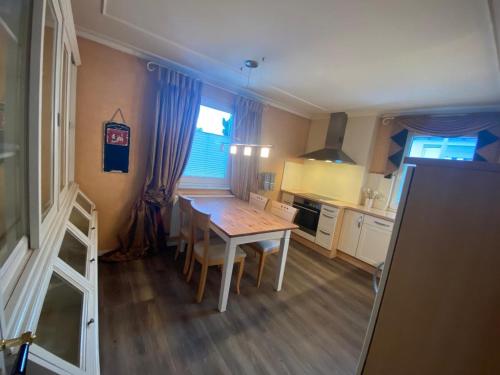a kitchen with a wooden table and a dining room at Haus mit 2 Schlafzimmern in Fulda