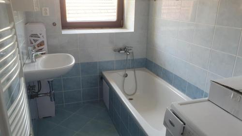 a bathroom with a sink and a bath tub and a sink at Ubytování v soukromí in Lomnice nad Lužnicí