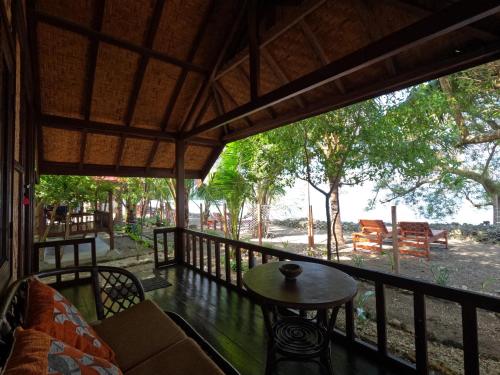 a view from the porch of a house with a table at Maryan Moyo Bungalows & Resto in Moyo Island