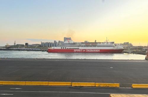 a cruise ship is docked in a harbor at Shore Getaway Spirit of Tasmania- 2 Mins in Norlane