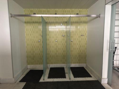 a shower with a glass door in a bathroom at Max Savassi Luxury in Belo Horizonte