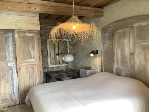 - une chambre avec un lit blanc et un lustre dans l'établissement Maison G, à Montréal