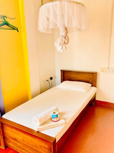 a bedroom with a bed with a tray of food on it at Railway Hostel in Matara