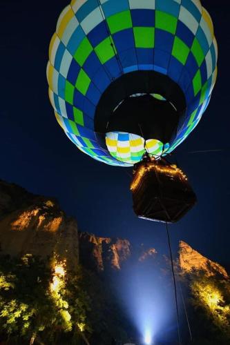 a blue and green balloon flying over a mountain at Villa Melnik SPA Residence with Hot Pool by BookVillaBG in Melnik