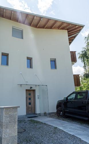 a black car parked in front of a white building at Venosta Valley - At the foot of the Stelvio Pass in Prato allo Stelvio