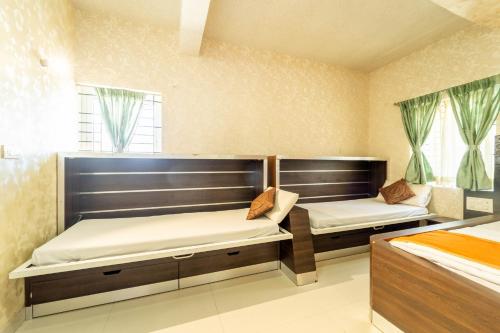 a bedroom with two beds and a window at Seasons Suites at Koramangala in Bengaluru