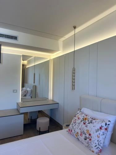 a bedroom with a bed and a desk and a mirror at Manolo & Jolie Luxury Villa in Himare