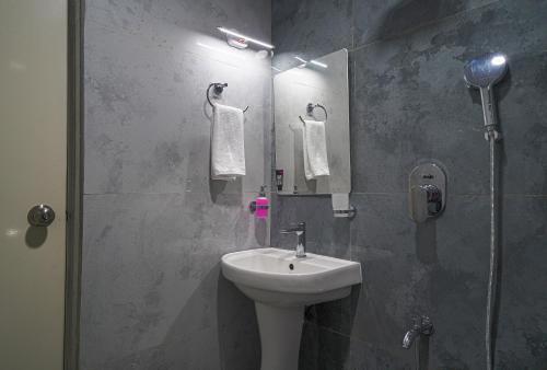 a bathroom with a sink and a mirror at Open Hotel by Olive - Ejipura in Bengaluru