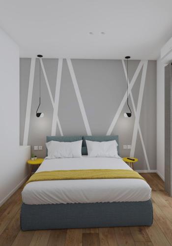 a bedroom with a large bed and two tables at Lᾶs Serifos in Livadi