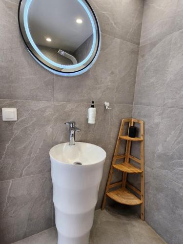 a bathroom with a white sink and a mirror at Lᾶs Serifos in Livadi