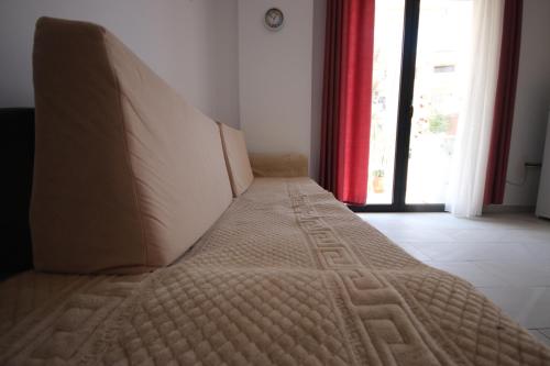a large bed sitting in a room with a window at IonianBlue Apartament I in Himare