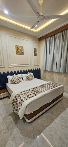 a bedroom with a large bed in a room at Hotel Nexus Inn in Ahmedabad