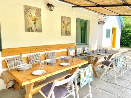 a wooden table and chairs on a patio at Bánhiday J70 Beach House in Balatonvilágos