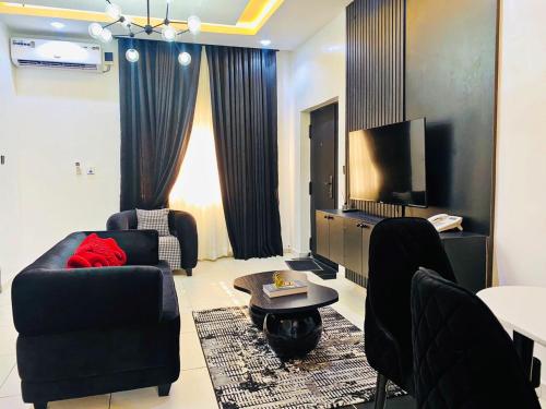 a living room with a couch and a tv at pearlsendapartments in Lagos
