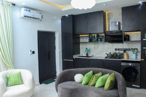 a living room with a couch and a kitchen at pearlsendapartments in Lagos