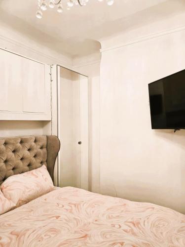 a bedroom with a bed and a flat screen tv at Beautiful Residential Within Easy Reach of Town in Haydock