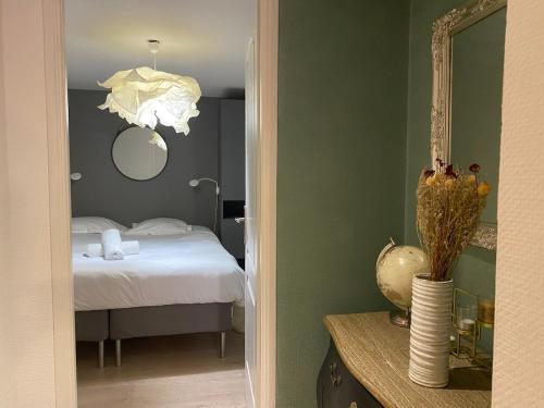 une chambre avec un lit, un miroir et une table dans l'établissement L'Accalmie, à Annecy