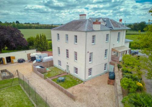 an aerial view of a large white house at Countryside Pod Retreat in Durston