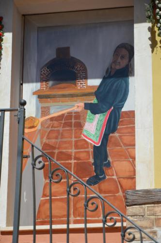 a painting of a woman on the side of a building at Gafo da Longa in Satriano