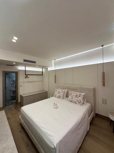 a bedroom with a large white bed with two pillows at Manolo & Jolie Luxury Villa in Himare