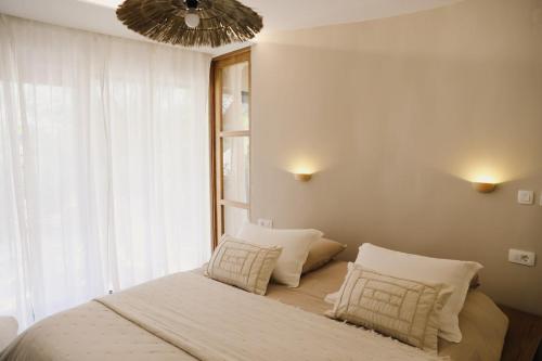 a bedroom with a bed with pillows and a window at Casa Casolare by The Residence in Bilice
