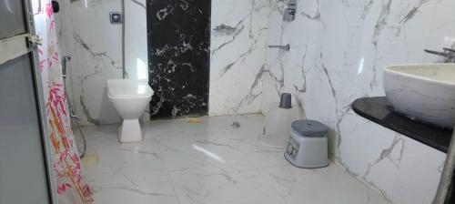 a bathroom with a sink and a toilet at Krushnakunj Holiday Resort, Nagaon in Alibaug