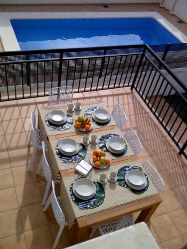 a table with plates and bowls of fruit on it at Rainbow Home Coll Verd in Playa de Gandia