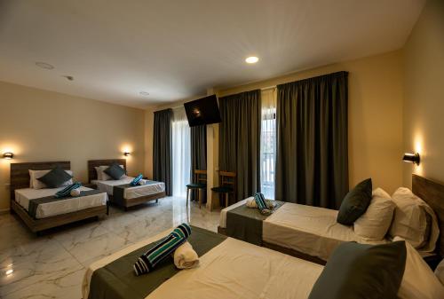 a hotel room with two beds and a couch at Euroclub Hotel in St Paul's Bay