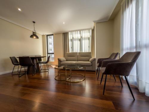 a living room with a couch and chairs and a table at Apartamentos Verdemar (VUT) in Llanes