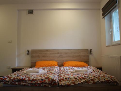 a bedroom with a bed with orange pillows at Apartment Pri nama in Bovec