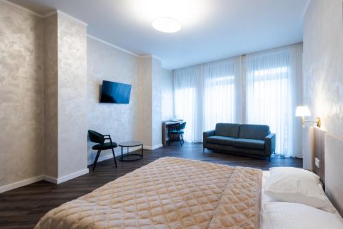 a hotel room with a bed and a couch at Nicole in Uzhhorod