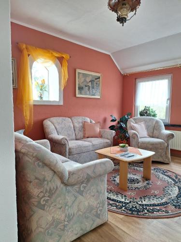 a living room with two couches and a table at Bei Oparius in Ganderkesee