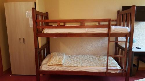 a couple of bunk beds in a room at Hotel Restaurant La Martiniere in Montélier
