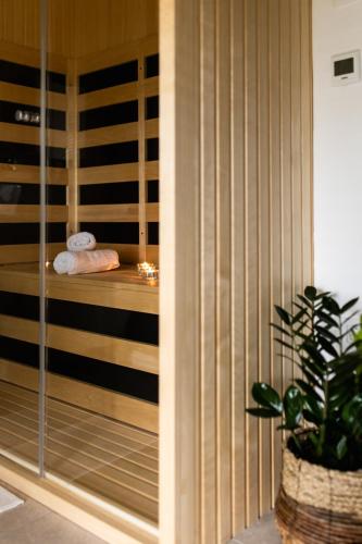 a spa room with a bed and a plant at Wellba Holiday Home Otlica in Ajdovščina