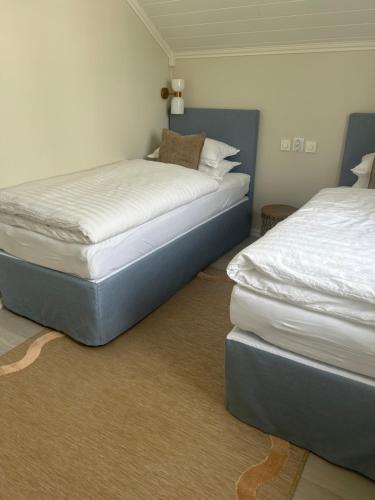 two beds sitting next to each other in a room at Sjøgata Gjestehus No2 in Larvik