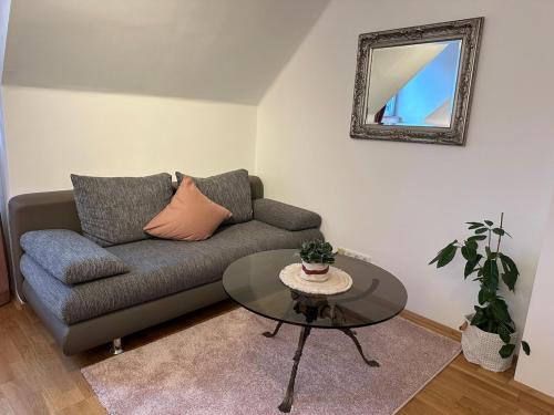 a living room with a couch and a table at Nest & Rest Garden Stay with Free Parking in Salzburg