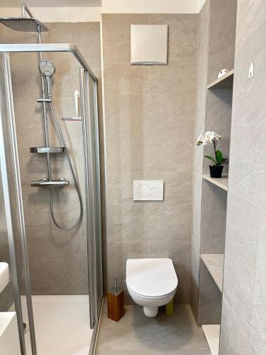 a bathroom with a shower and a toilet in it at Nest & Rest Garden Stay with Free Parking in Salzburg