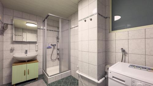 a bathroom with a sink and a shower at Gemütliches Apartment in Velden in Velden am Wörthersee