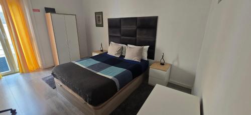 una camera da letto con un letto grande in una stanza di Lisbon Apartments in Anjos a Lisbona