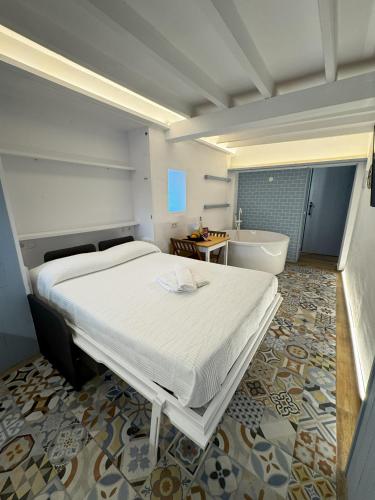 a bedroom with a large bed and a bath tub at Viura - Harbor's Light in Villajoyosa
