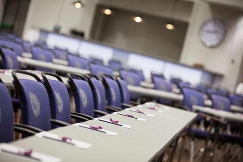 a row of tables and chairs in a classroom at Scandic Harstad in Harstad