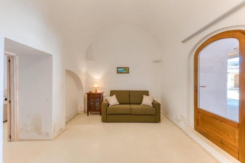 a living room with a couch and a window at Masseria Scafazzi - Salento in Presicce