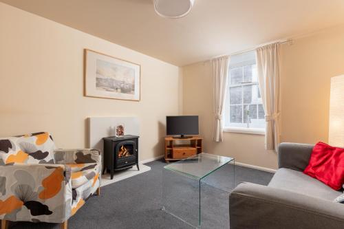 a living room with a couch and a glass table at Discovery Accommodation in Whitby